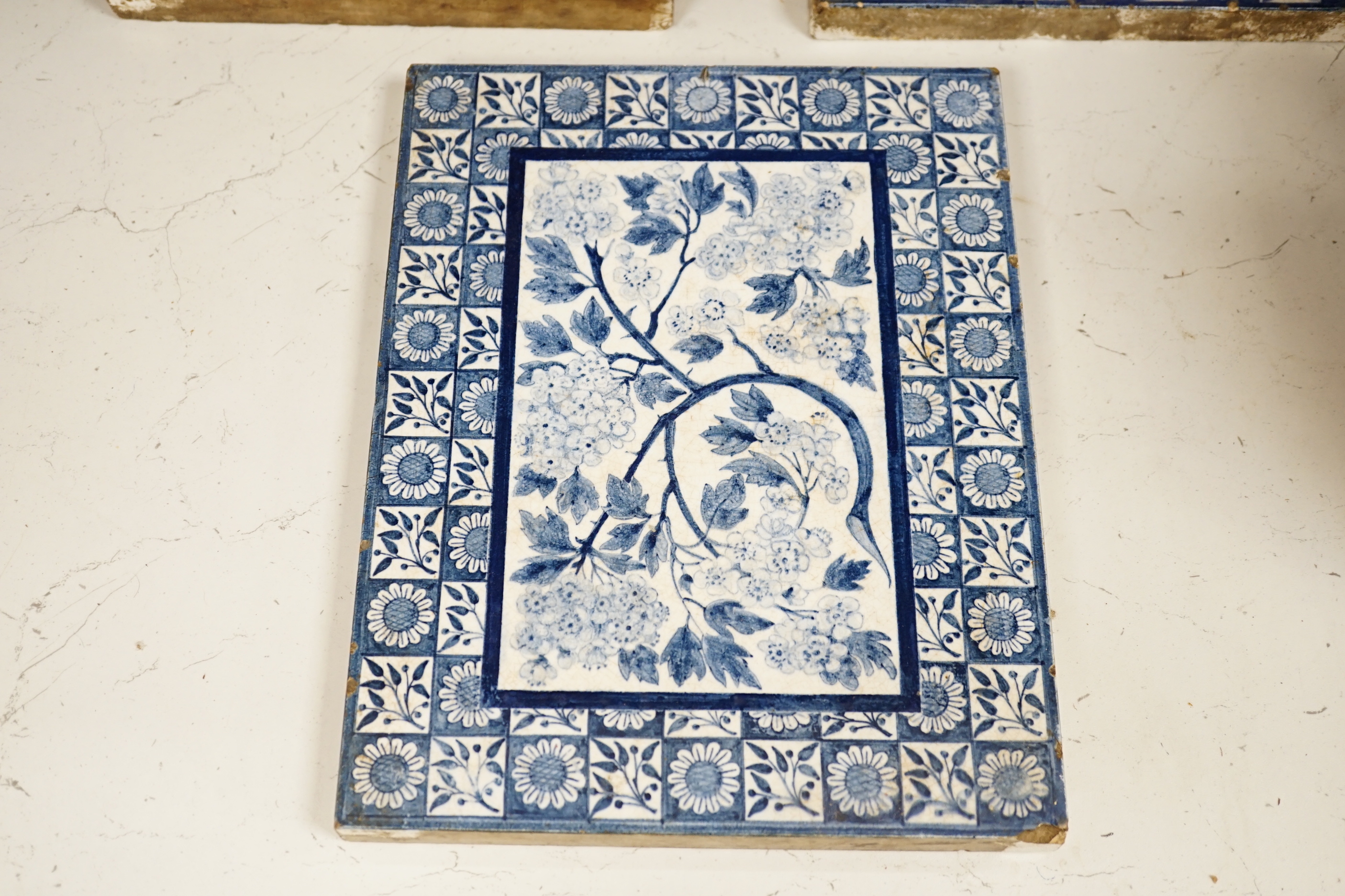 Three Victorian blue and white Mintons tiles decorated with flowers and fruit, each stamped to the base, each 29cm x 22cm